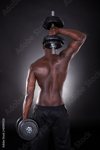 Foto-Banner aus PVC - Man Exercising With Dumbbells (von Andrey Popov)