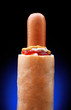 French hot dog with three sauces on black background