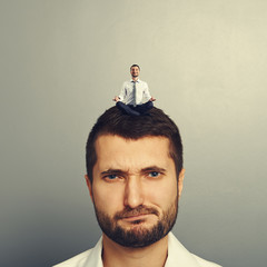 Poster - dissatisfied man with small man on the head