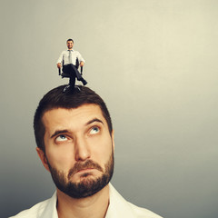 Wall Mural - man looking up at small successful man