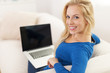 © gpointstudio - Happy woman using laptop at home