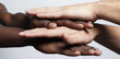 © cristovao31 - Multiracial hands together forming a pile over gray background