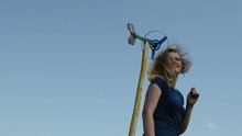 Beauty Woman Walk Arround Spin Windmill Pinwheel Toy On Blue Sky
