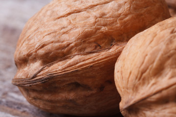 Poster - two walnuts in the shell macro on an old wooden table