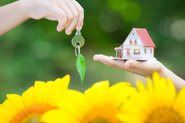 Ecology house and key in hands