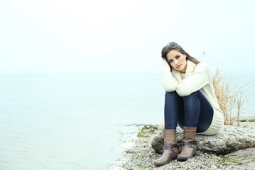 Wall Mural - Portrait of young serious woman near river