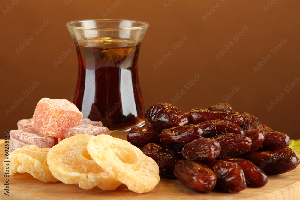 Dried dates with cup of tea and sweets