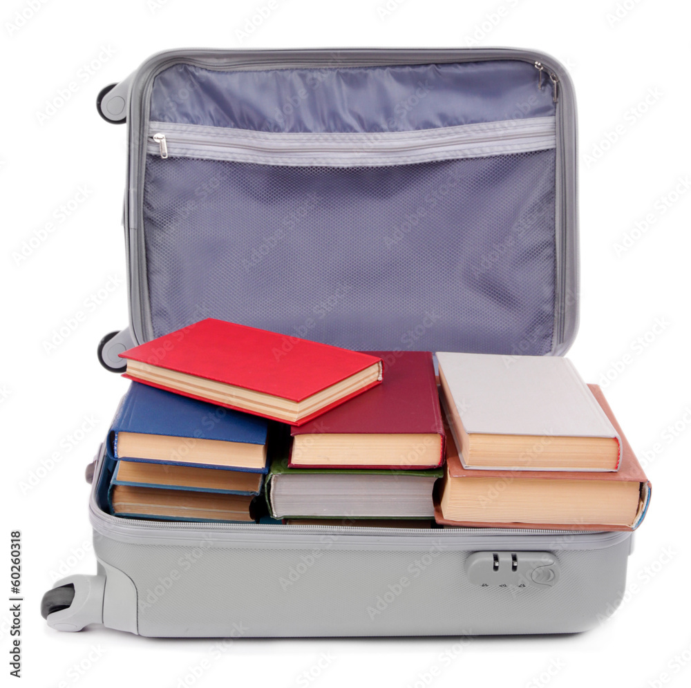 Suitcase with books isolated on white