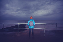Hiker Standing By The Sea On A Stormy Day