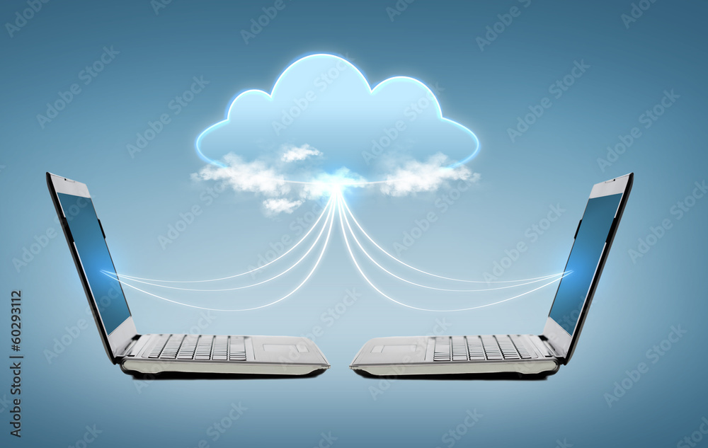 two laptop computers with world map hologram