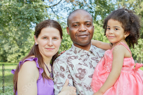 Portrait Of White Mother And Black Father Who Holds Daughter Stock