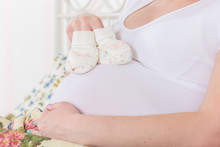 Pregnant Woman With Children's Bootees