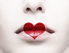 Close Up Of Female Lips With Red Heart Shape Painted On It