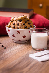 Wall Mural - Chocolate chip cookies and milk on wood background