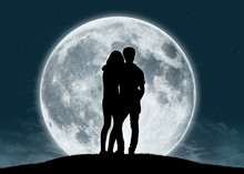 Young Couple In Love At The Full Moon
