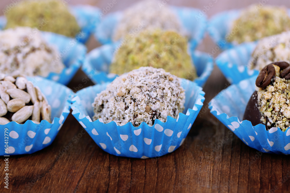 Set of chocolate candies, on wooden background