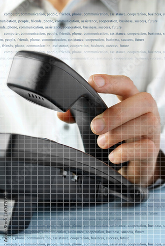 in the office of a man holding up the phone Slika na platnu