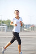 © puhhha - Athletic Runner Training in a park for Marathon.