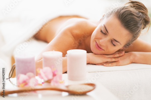 Fotografie, Obraz Closeup on spa therapy ingredients and woman in background