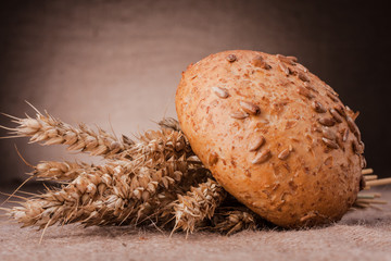 Loaf of bread and wheat ears still life