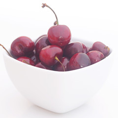 Wall Mural - Cherries in a ceramic bowl isolated on white