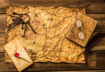 Wall Mural - Different tools  on vintage map over wooden background