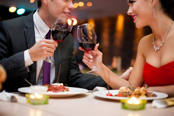 couple toasting wine glasses