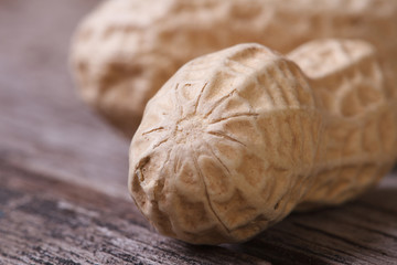 Poster - peanuts in shell closeup on a wooden table