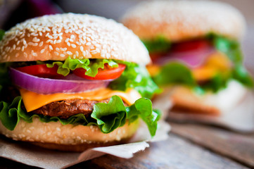 Closeup of home made burgers on wooden background