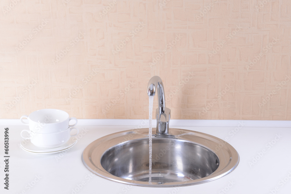Water tap and sink in  modern kitchen