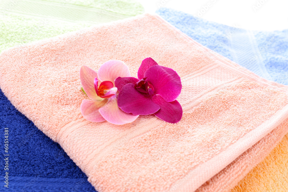 Orchid flower and towels, close-up