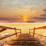 Fototapeta Zachód słońca - Boardwalk on beach