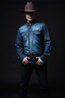 © ysbrandcosijn - Modern fashion cowboy. Wearing brown hat and blue jeans shirt. B