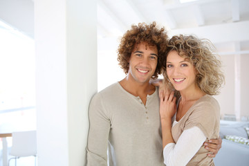 Attractive smiling couple in new home