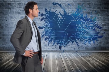 Poster - Composite image of smiling businessman with hand on hip
