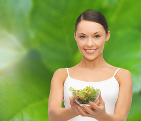 healthy woman holding bowl with salad