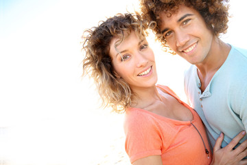 Wall Mural - In love couple embracing each other at the beach