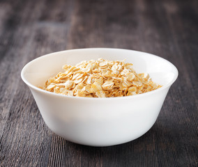 Canvas Print - Bowl of oatmeal on wooden table