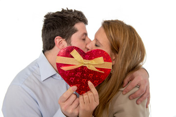 love heart with a young couple kissing in back ground