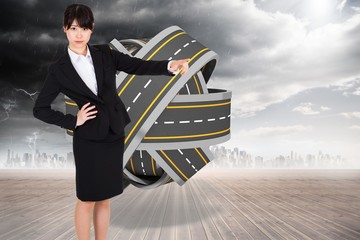 Poster - Composite image of businesswoman pointing