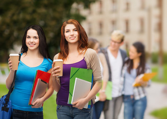 Wall Mural - two students with bag, folders, tablet and coffee