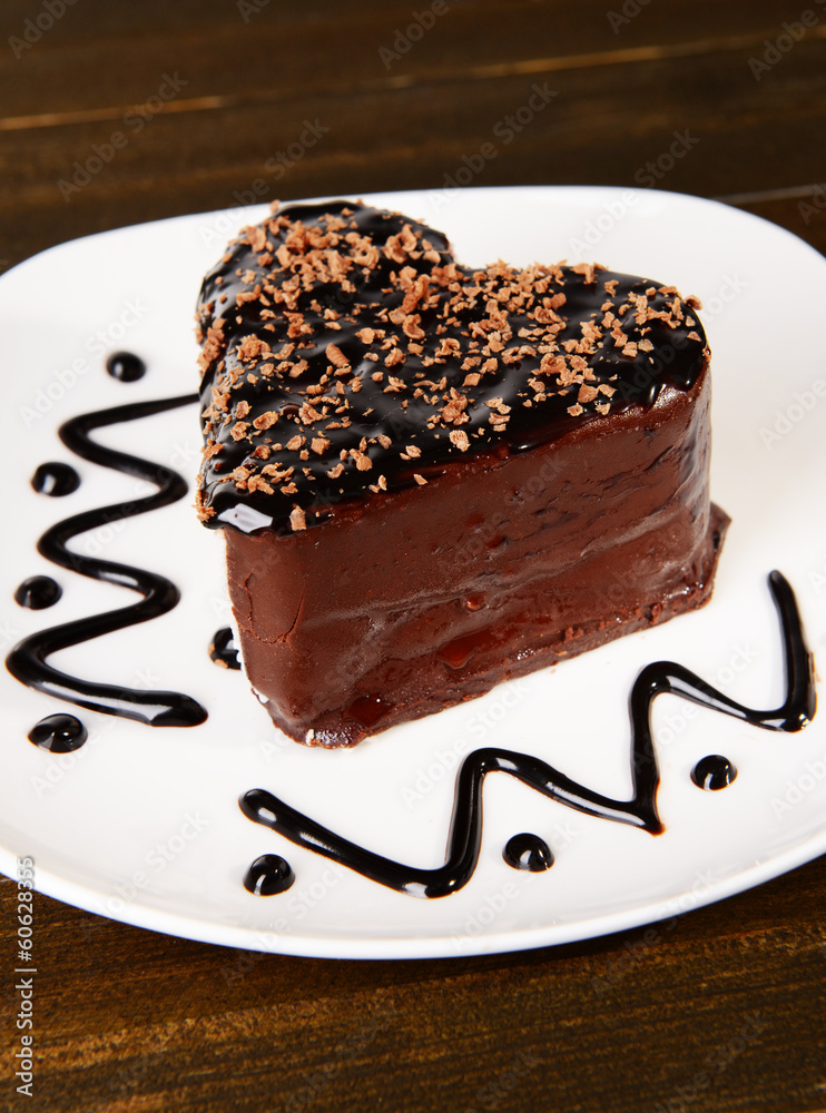 Sweet cake with chocolate on plate on table close-up
