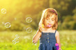 © JenkoAtaman - little girl blowing soap bubbles in nature