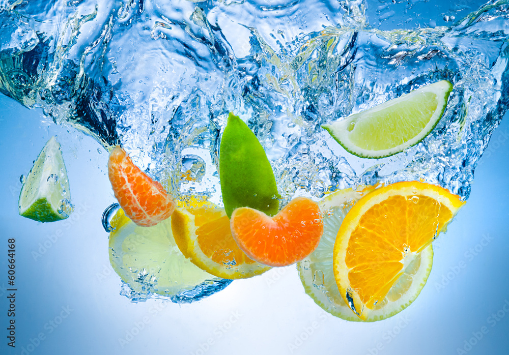 Tropical fruits fall deeply under water with a big splash