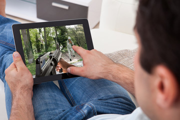 Poster - Man Playing Game On Tablet Pc