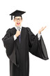 © Ljupco Smokovski - Male graduate student holding a speech on microphone