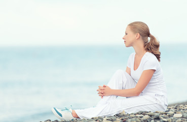 Wall Mural - woman in white relax resting on the sea on the beach