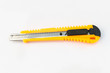 The yellow stationery knife on white background