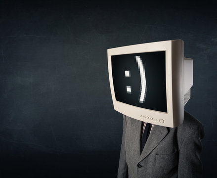 Funny young businessman with a monitor on his head and smiley on