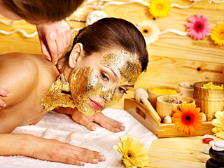 Woman getting  facial mask .